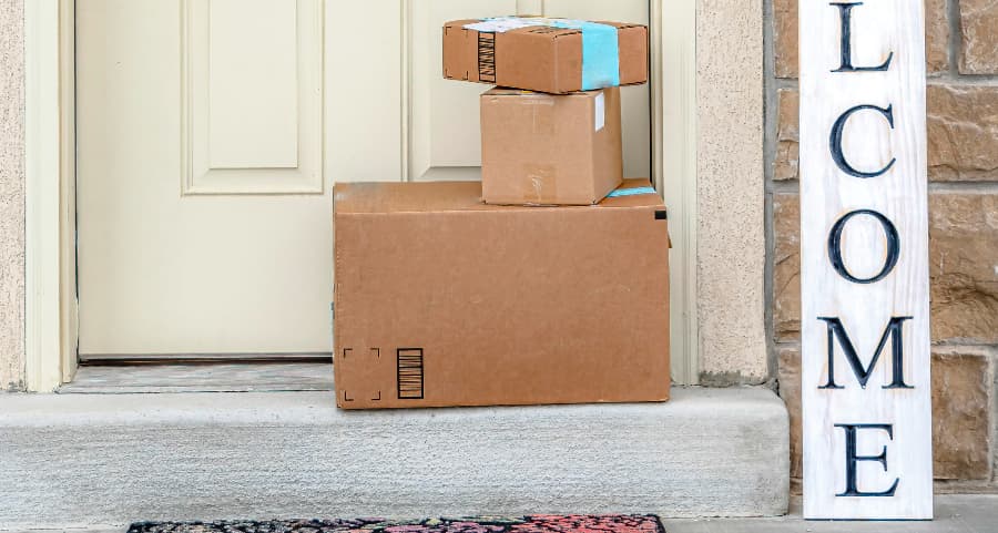 Deliveries on the front porch of a house with a welcome sign in Erie